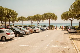 Parking près de la plage de Carry-le-Rouet avec des familles se dirigeant vers la mer en été